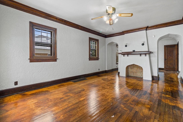 unfurnished living room featuring ceiling fan, dark hardwood / wood-style flooring, and crown molding