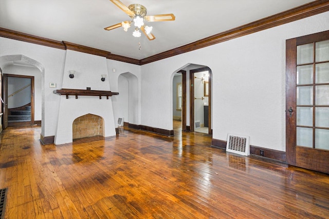 unfurnished living room with dark hardwood / wood-style floors, ceiling fan, and crown molding