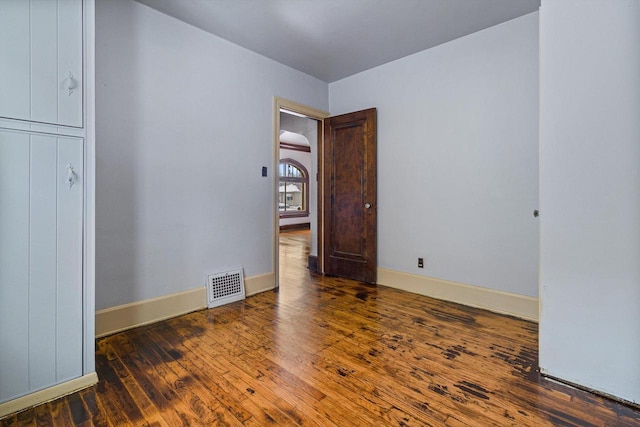 unfurnished bedroom with dark hardwood / wood-style floors