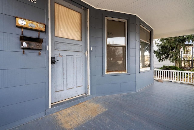 view of exterior entry featuring a porch