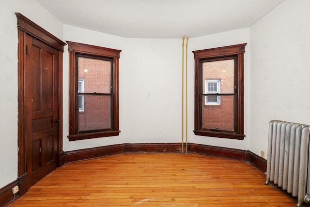 empty room featuring light hardwood / wood-style floors and radiator