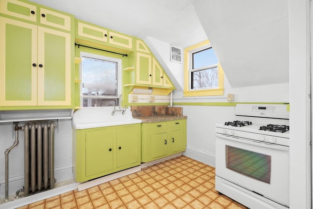 kitchen featuring white gas range, radiator heating unit, sink, and green cabinetry