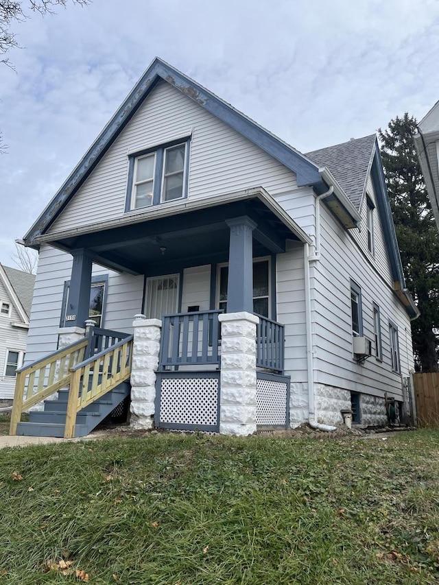 bungalow-style house featuring a porch and cooling unit