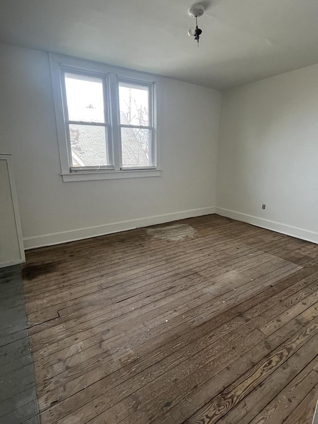 spare room with dark hardwood / wood-style flooring