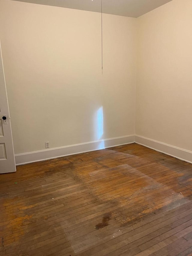 empty room featuring dark wood-type flooring