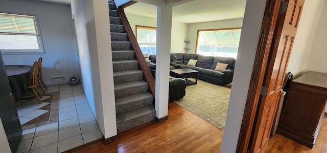 stairs with hardwood / wood-style floors