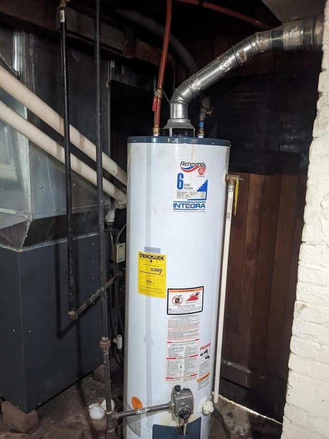 utility room with heating unit and water heater