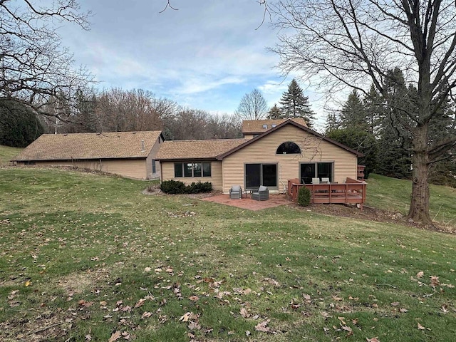 back of house featuring a wooden deck, a patio area, and a yard