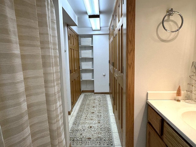 bathroom featuring tile patterned flooring and vanity