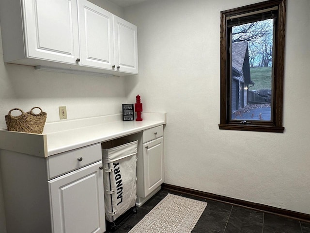 bar with white cabinetry and dark tile patterned flooring