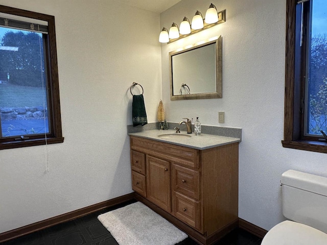 6641 N Kennedy Rd, Milton, WI 53563 - half bathroom featuring vanity, toilet, and baseboards