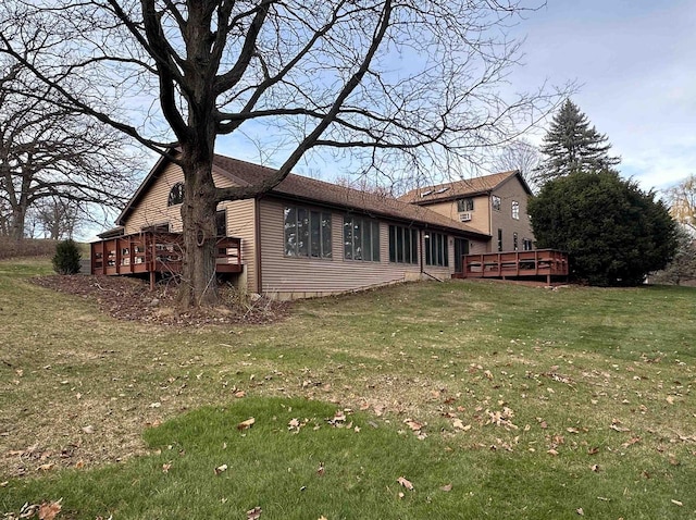 exterior space featuring a lawn and a deck