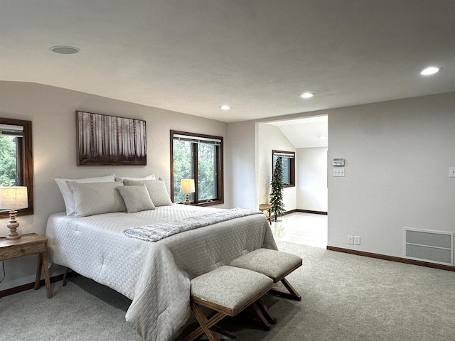 carpeted bedroom with lofted ceiling and multiple windows