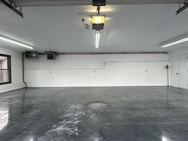 6641 N Kennedy Rd, Milton, WI 53563 - garage with a garage door opener, a heating unit, and baseboards