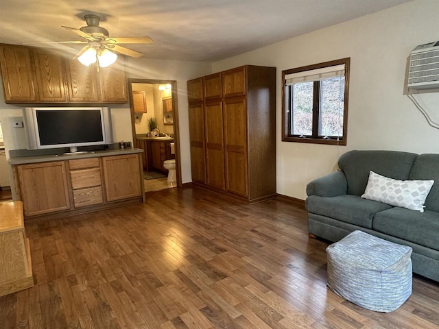 living room with dark hardwood / wood-style floors, ceiling fan, and sink