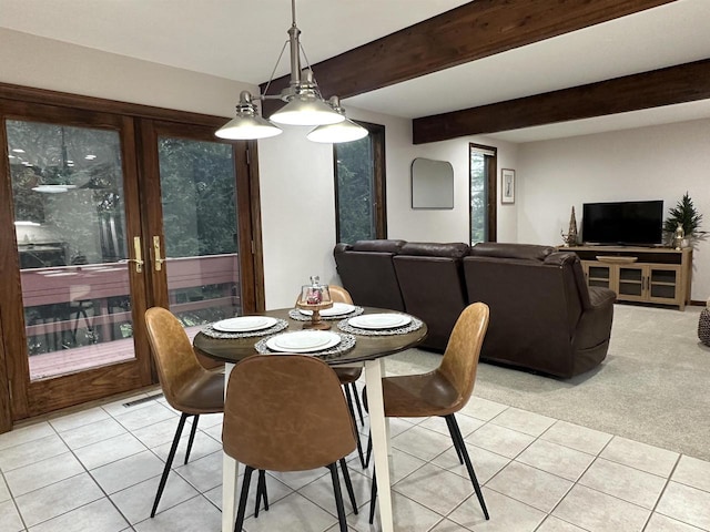 carpeted dining room featuring beamed ceiling