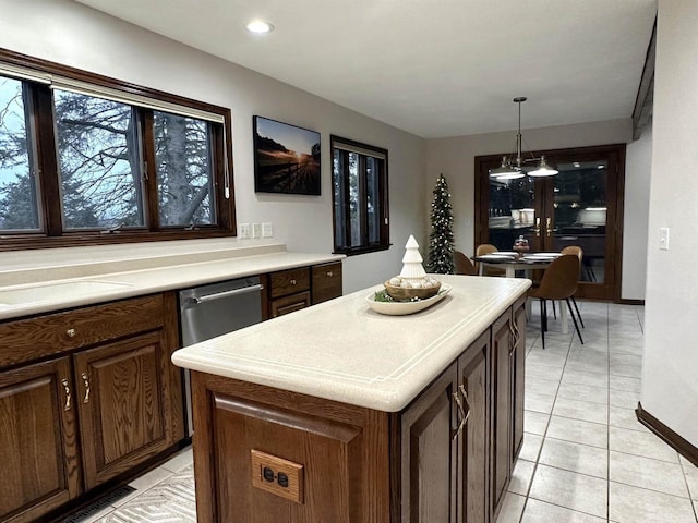 6641 N Kennedy Rd, Milton, WI 53563 - kitchen with a center island, light countertops, light tile patterned floors, pendant lighting, and baseboards