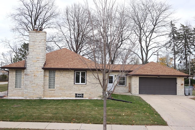 view of front of home with a front yard and a garage