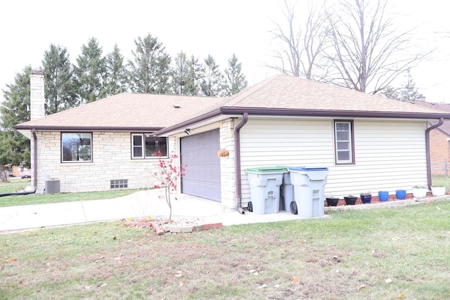 exterior space with a garage, a front lawn, and central air condition unit