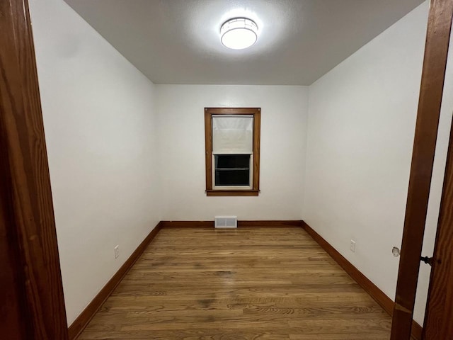 empty room with hardwood / wood-style flooring