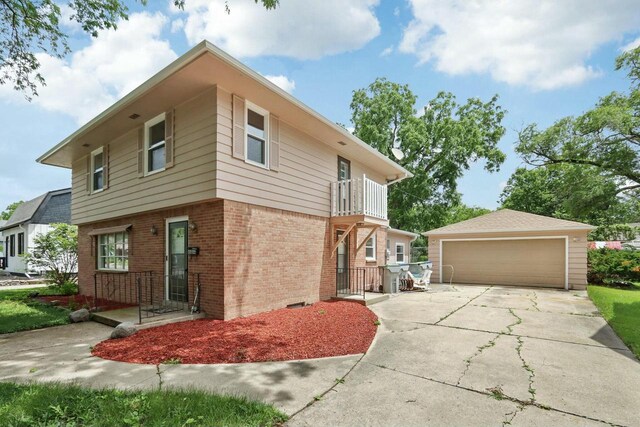 view of side of home featuring an outbuilding, a balcony, and a garage