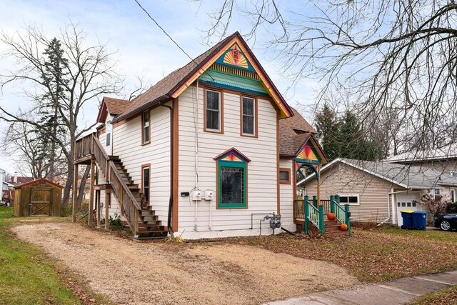 130 W Maple St, Viroqua, WI 54665 - victorian house featuring stairway, a storage unit, and roof with shingles