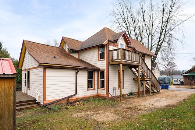 130 W Maple St, Viroqua, WI 54665 - view of home's exterior featuring a wooden deck, stairs, and a shingled roof