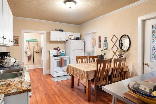 130 W Maple St, Viroqua, WI 54665 - dining space with crown molding, a textured ceiling, and light wood-type flooring