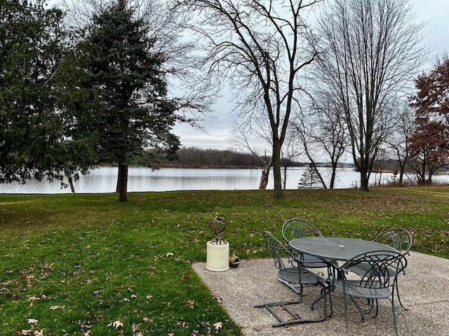 view of yard with a water view and a patio