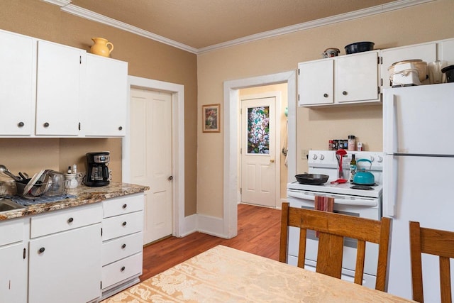 130 W Maple St, Viroqua, WI 54665 - kitchen with white appliances, ornamental molding, light wood-style floors, white cabinets, and baseboards