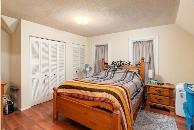 130 W Maple St, Viroqua, WI 54665 - bedroom with wood finished floors, a textured ceiling, and multiple closets