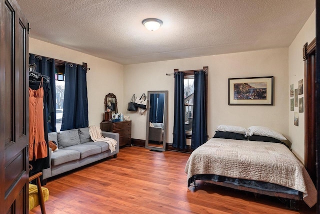 130 W Maple St, Viroqua, WI 54665 - bedroom featuring wood finished floors and a textured ceiling