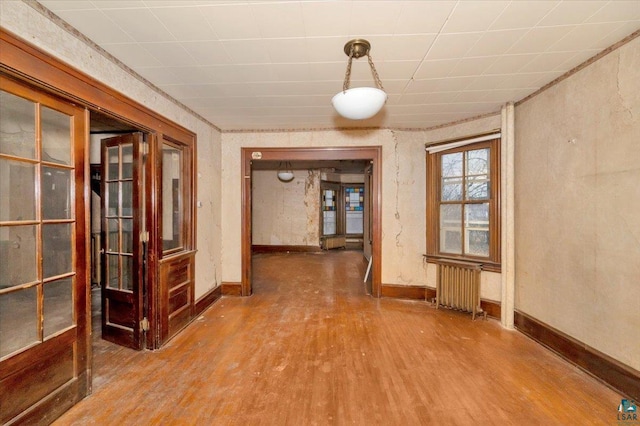 interior space featuring radiator heating unit and hardwood / wood-style flooring