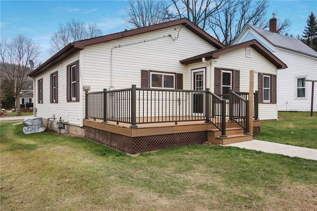 back of property featuring a lawn and a deck