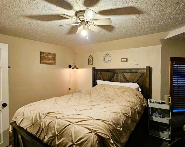 bedroom with ceiling fan and a textured ceiling