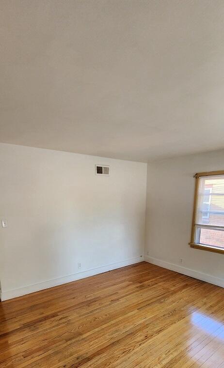 unfurnished room featuring light hardwood / wood-style floors