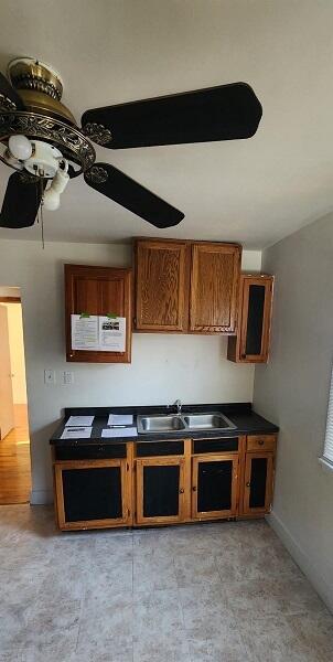 kitchen featuring ceiling fan and sink