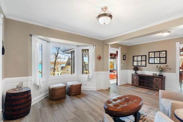 2572 N Shore Dr, Delavan, WI 53115 - living area with a wainscoted wall, wood finished floors, and crown molding