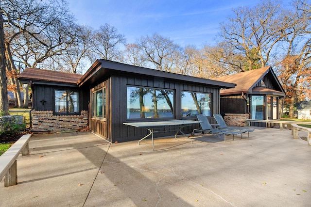 2572 N Shore Dr, Delavan, WI 53115 - rear view of property with a patio and board and batten siding