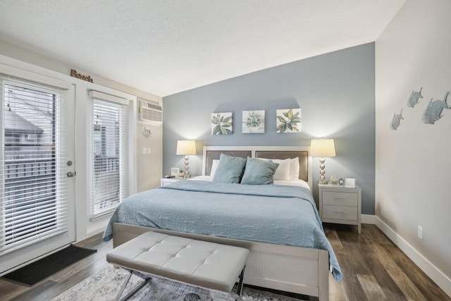 bedroom with a textured ceiling, access to exterior, vaulted ceiling, and dark hardwood / wood-style floors