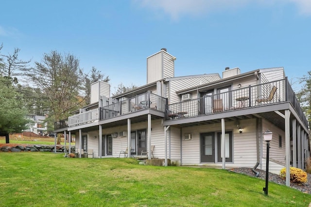 back of house with a wooden deck and a lawn