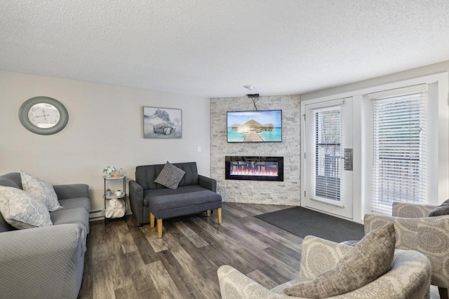 1093 Canyon Rd Unit 406, Wisconsin Dells, WI 53965 - living area featuring a textured ceiling, wood finished floors, a large fireplace, and baseboard heating