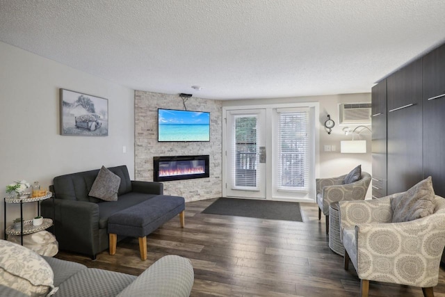 1093 Canyon Rd Unit 406, Wisconsin Dells, WI 53965 - living area with wood finished floors, a fireplace, a textured ceiling, and a wall unit AC