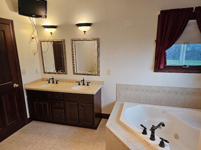 bathroom featuring tile patterned flooring, vanity, and tiled tub