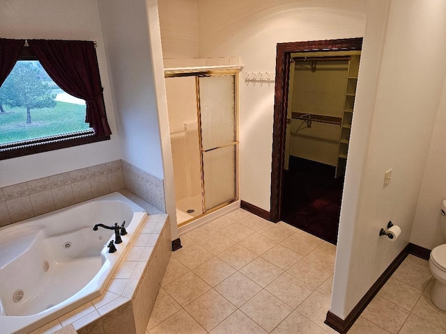 bathroom with tile patterned flooring, toilet, and shower with separate bathtub