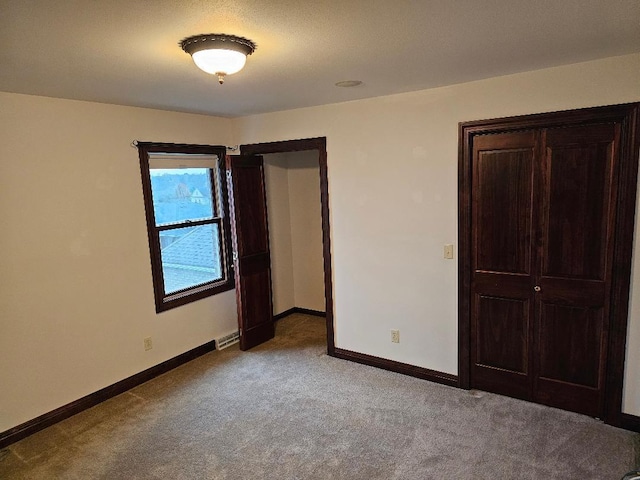 unfurnished bedroom featuring light colored carpet