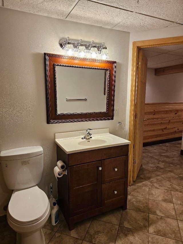 bathroom with tile patterned flooring, vanity, and toilet