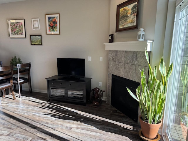 living room with a tiled fireplace