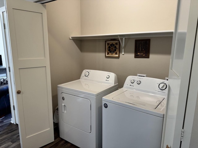 clothes washing area with dark hardwood / wood-style flooring and separate washer and dryer