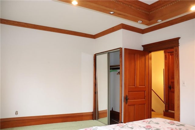 unfurnished bedroom featuring crown molding and a closet